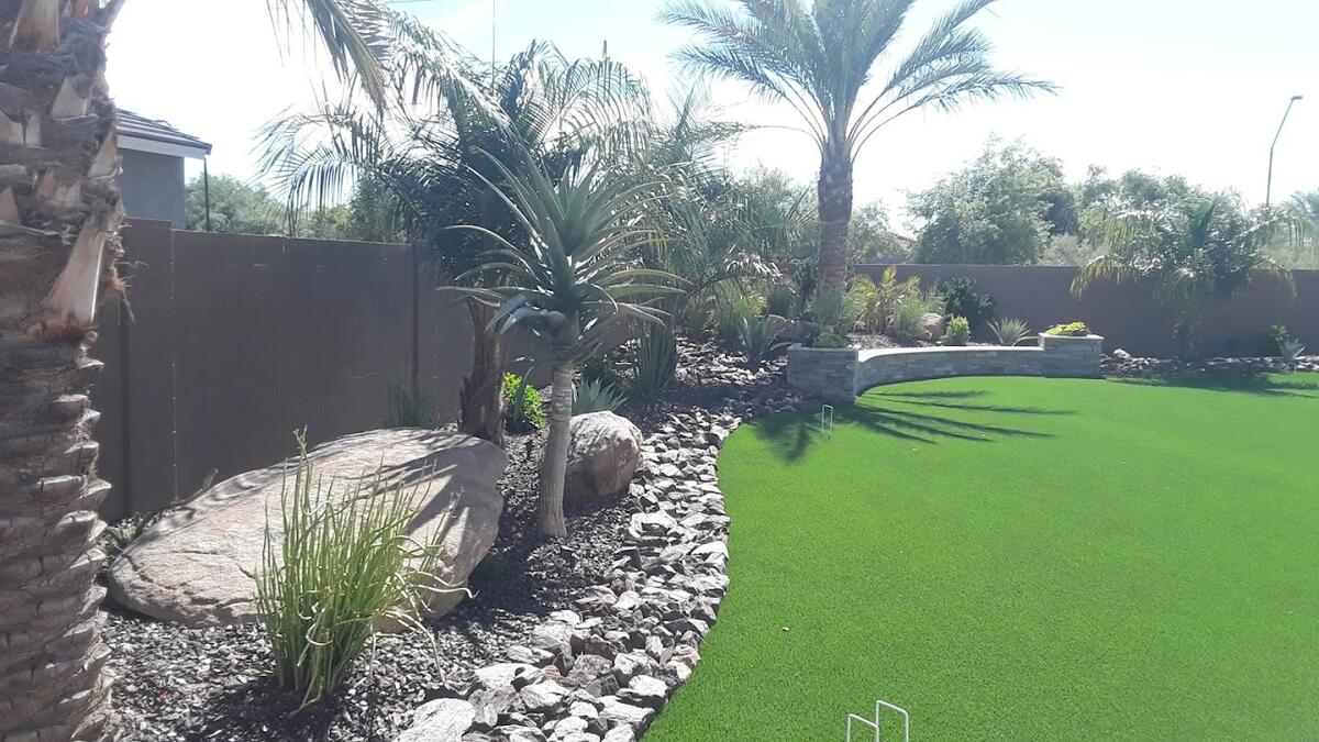 Tropical backyard with artificial turf and palms in Phoenix, AZ