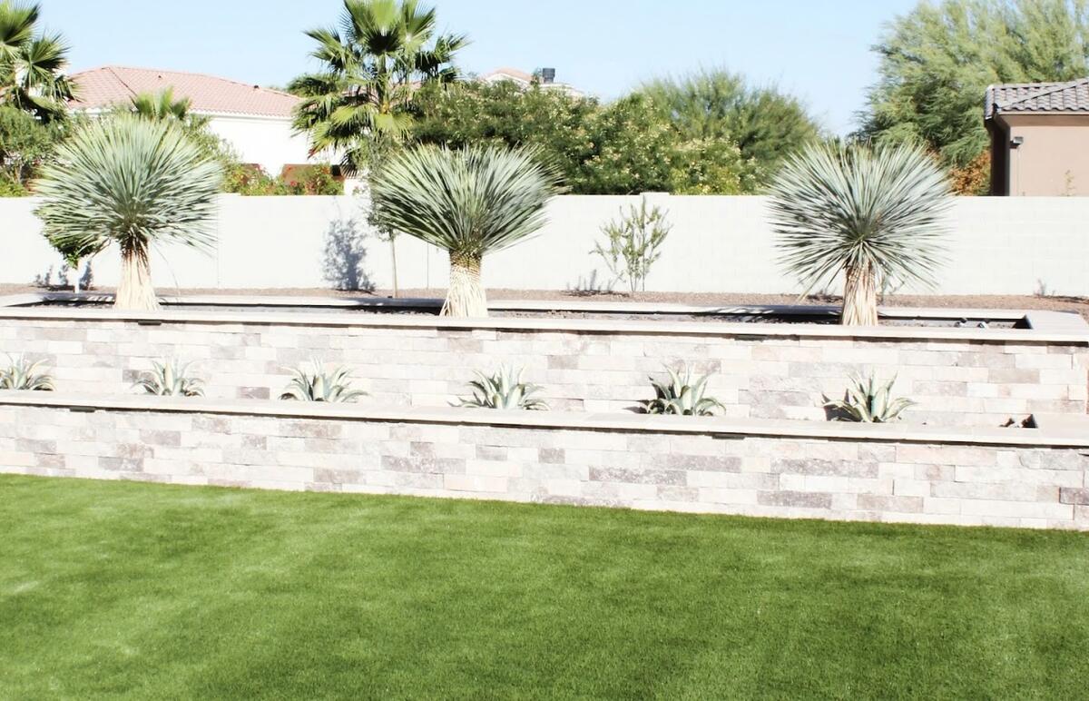Stone retaining wall with yucca trees in Mesa, AZ