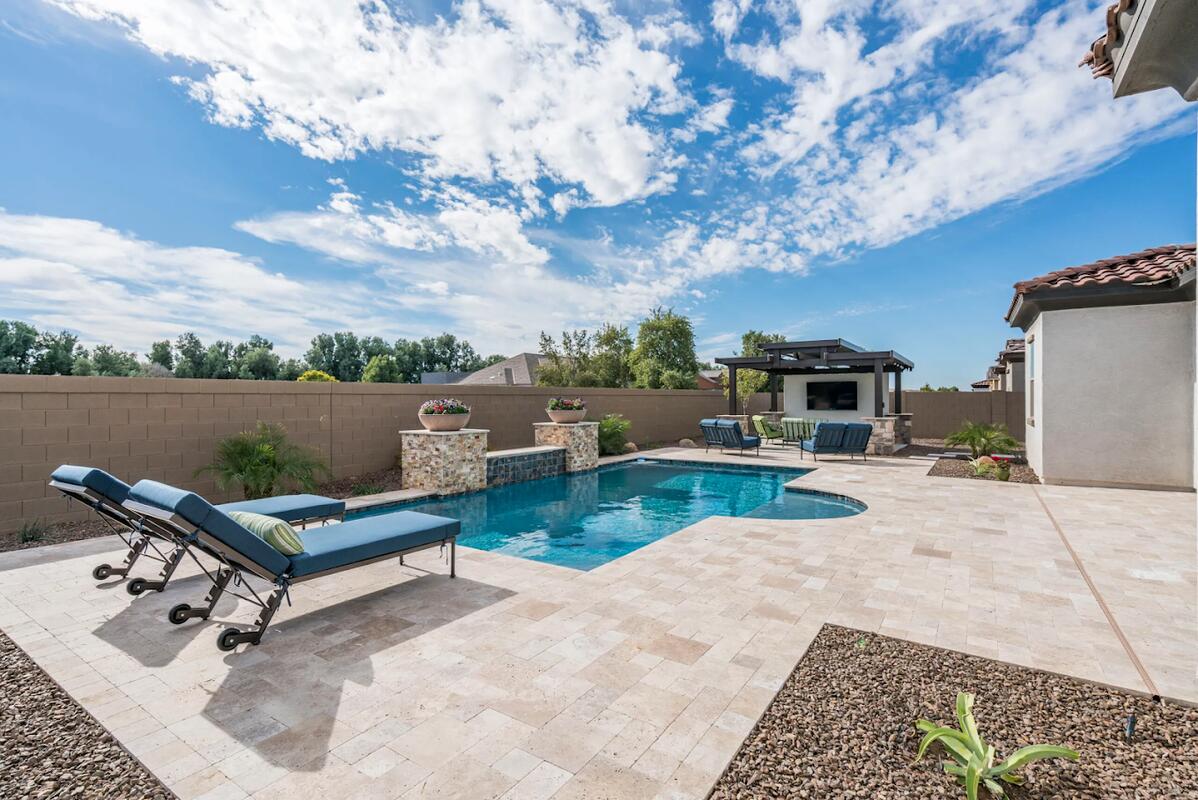 Travertine paver pool deck with pergola in Gilbert, AZ